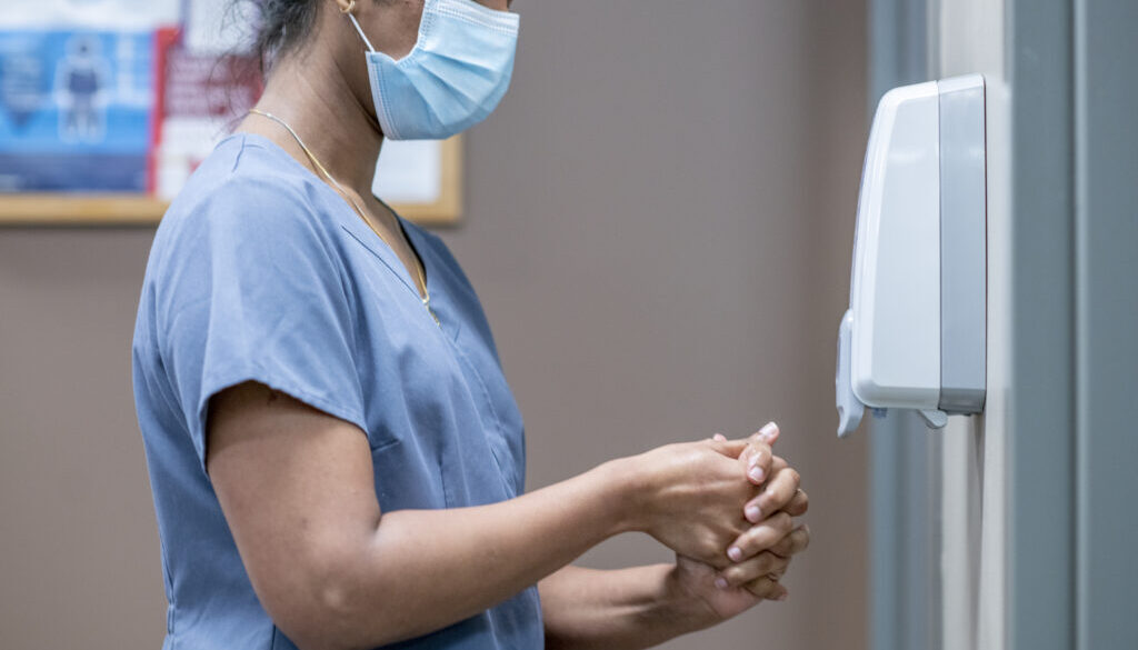 Nurse sanitizes hands